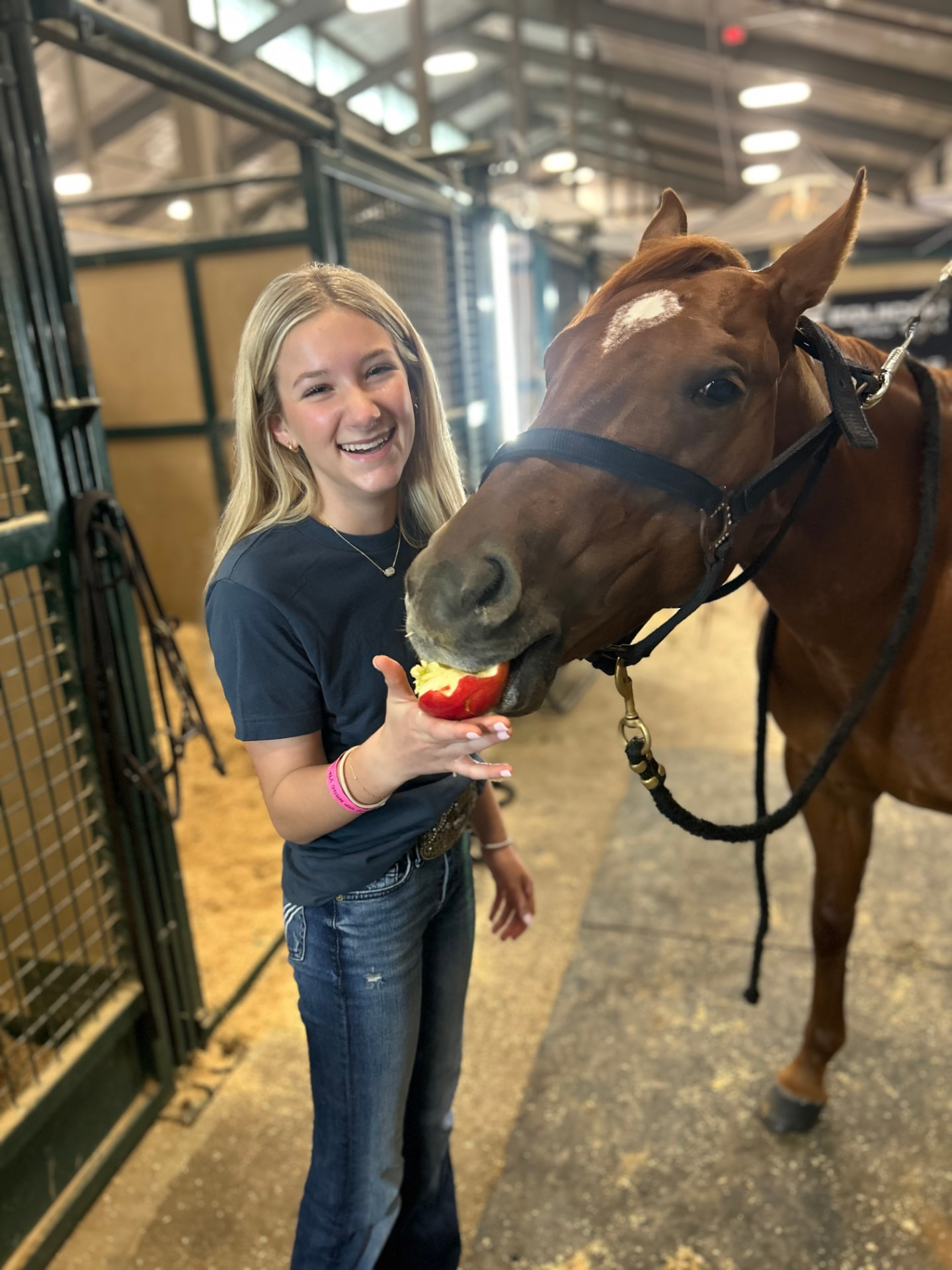 Morgan feeding her horse an apple