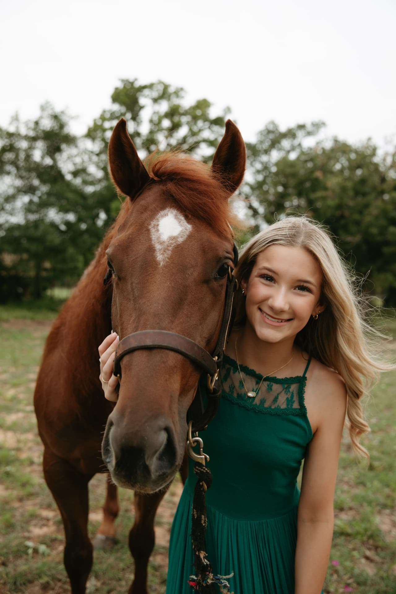 Morgan with her sorrel horse in the pasture